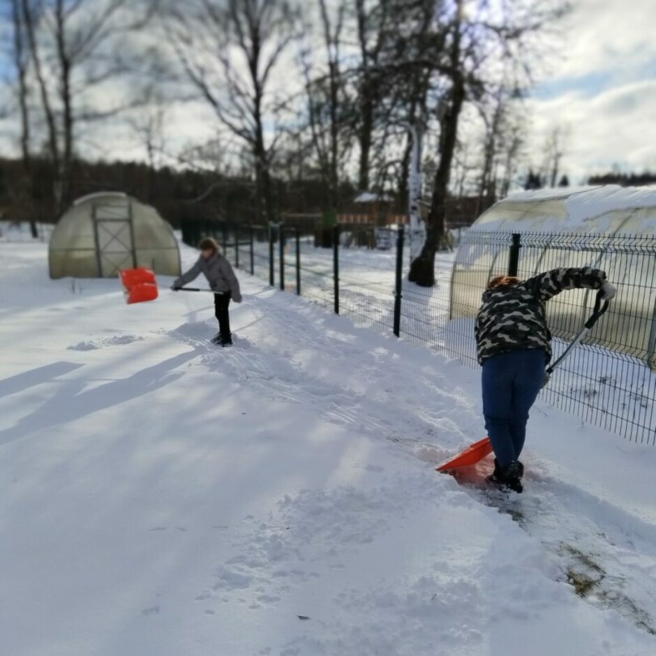 Bērni šķūrēs sniegu