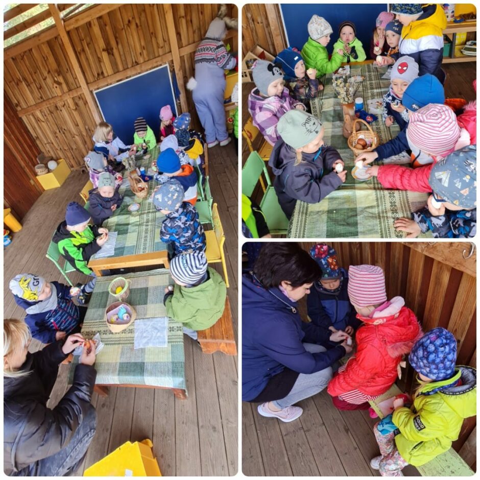 Grupas bērni āra nojumē loba un ēd Lieldienu olas.