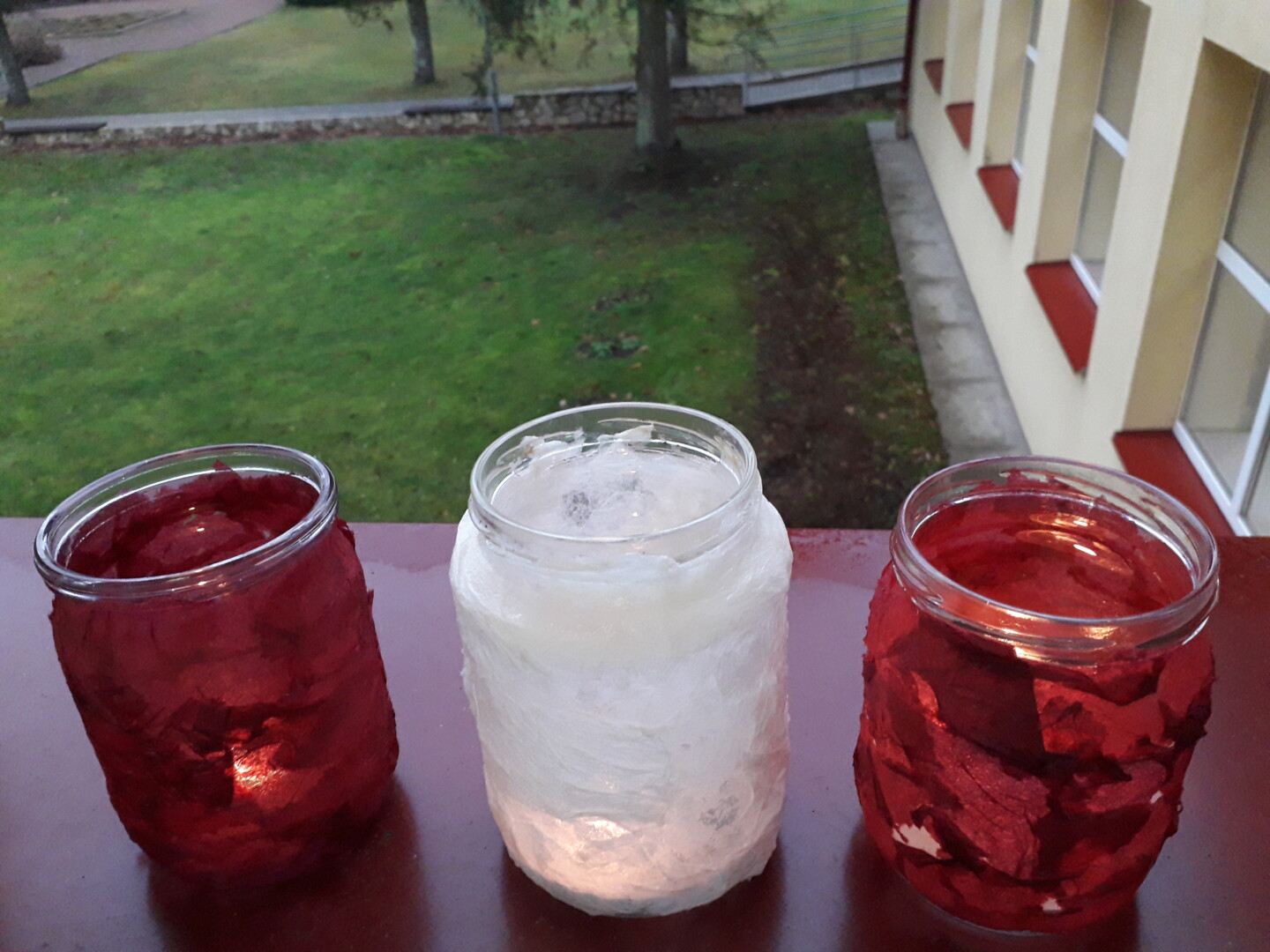 aplīmētas trīs burciņas ar svecītēm - sarkana, balta, sarkana