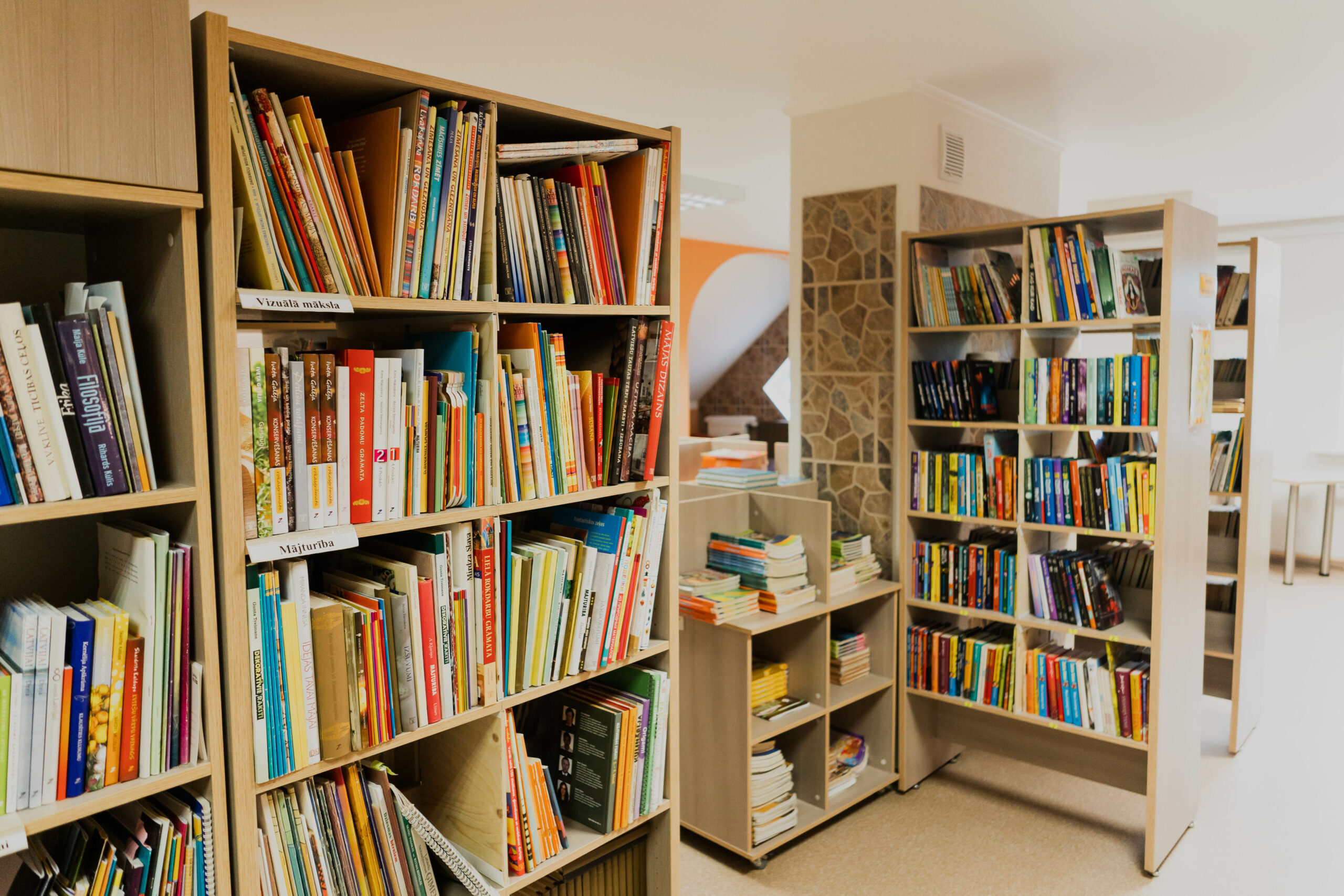 bibliotēkas plaukti ar grāmatām