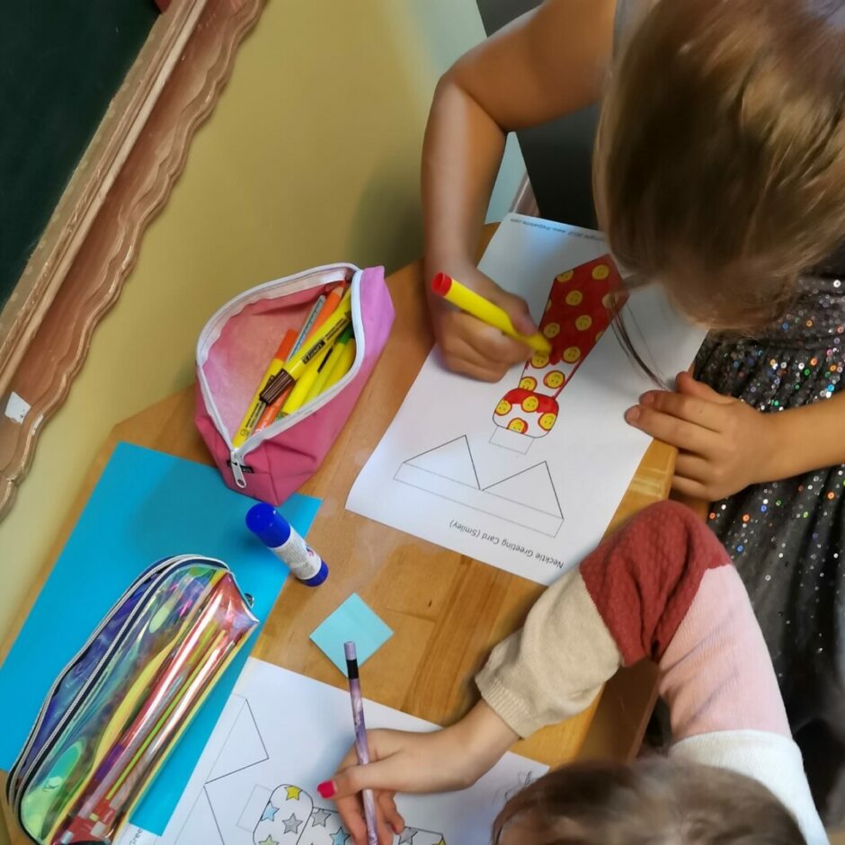 Tēva diena - divi bērni krāso apsveikumu